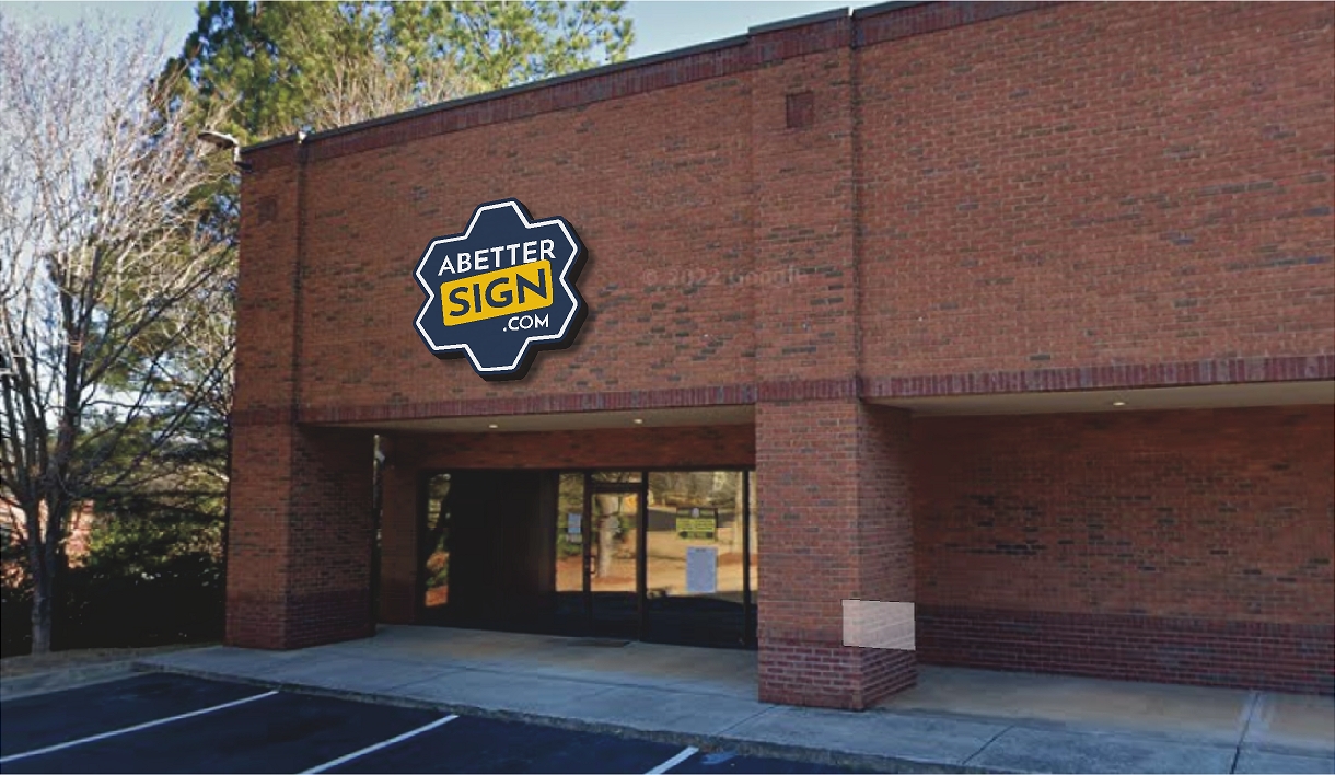 Exterior of ABetterSign.com building in Suwanee, GA featuring a custom mounted business sign on a brick commercial storefront