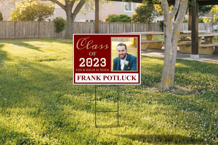 picture of graduate on sign in a yard