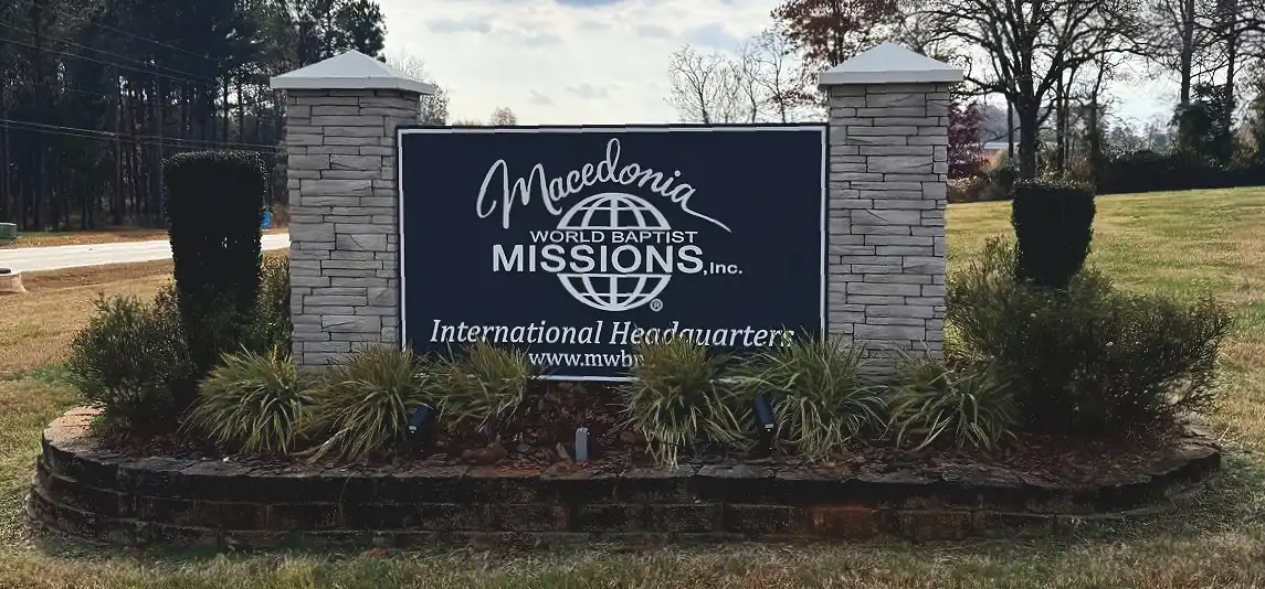 macedonia world baptists missions inc international headquarters sign in grass with bricks