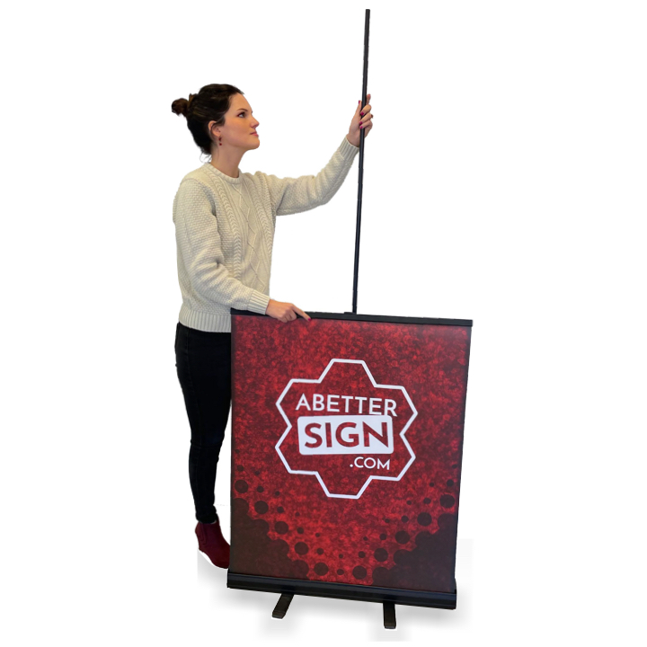 Girl pulling up retractable banner with ease